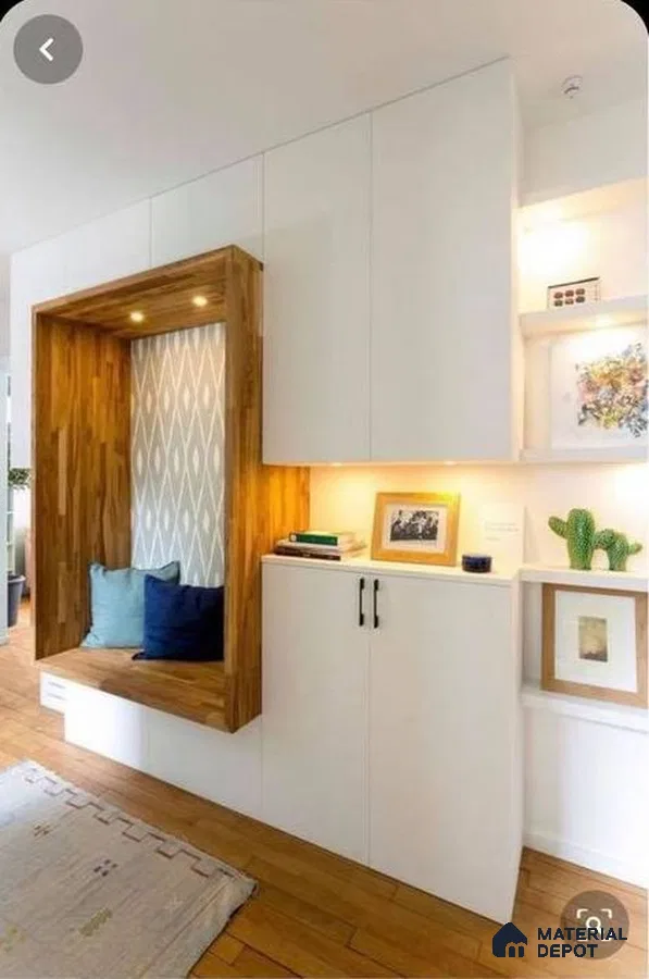 A kitchen with wooden cabinets and white counter tops, along with an island in the middle of the middle of the room with wood flooring and white counter top space to a kitchen filled with wooden cabinets and white